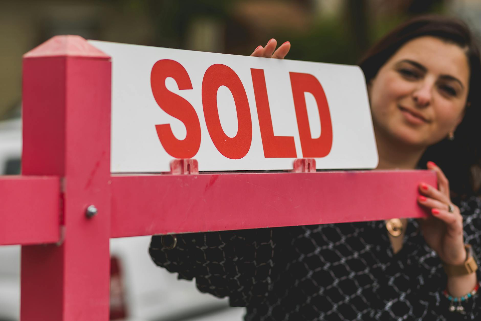 real estate agent holding a signage